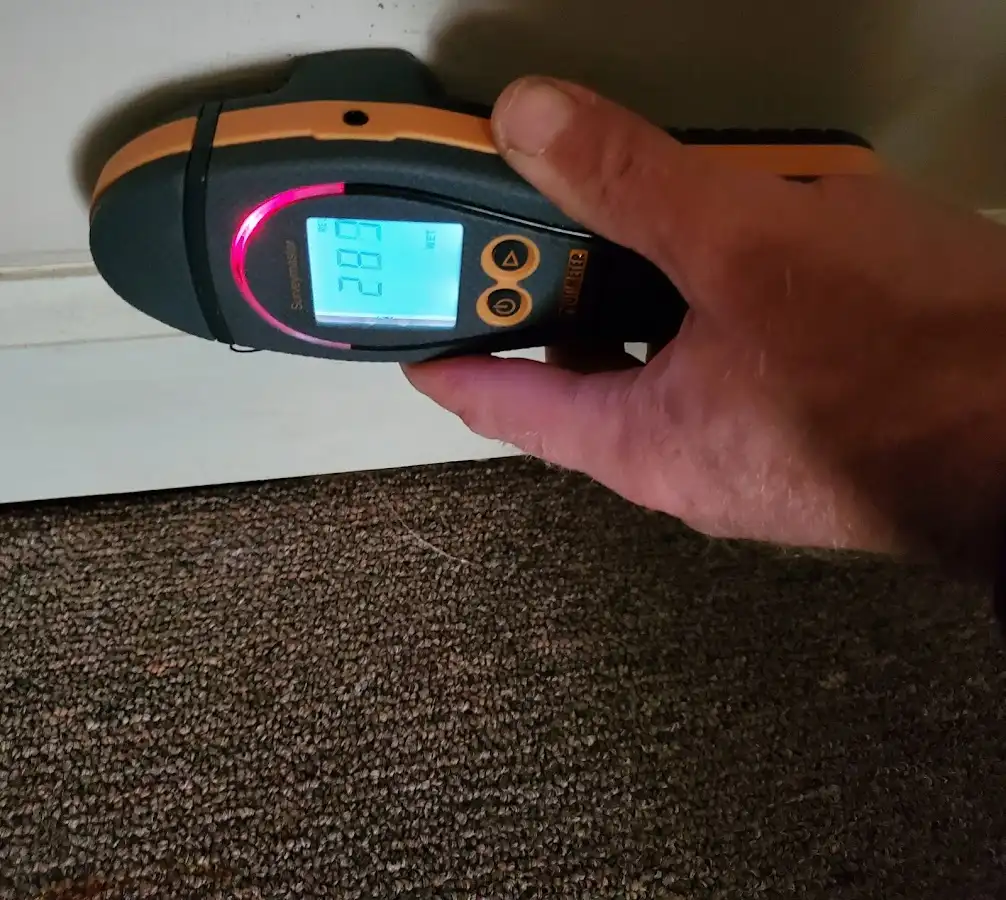 Moisture detection at baseboard during Storm Damage Restoration in Hannibal